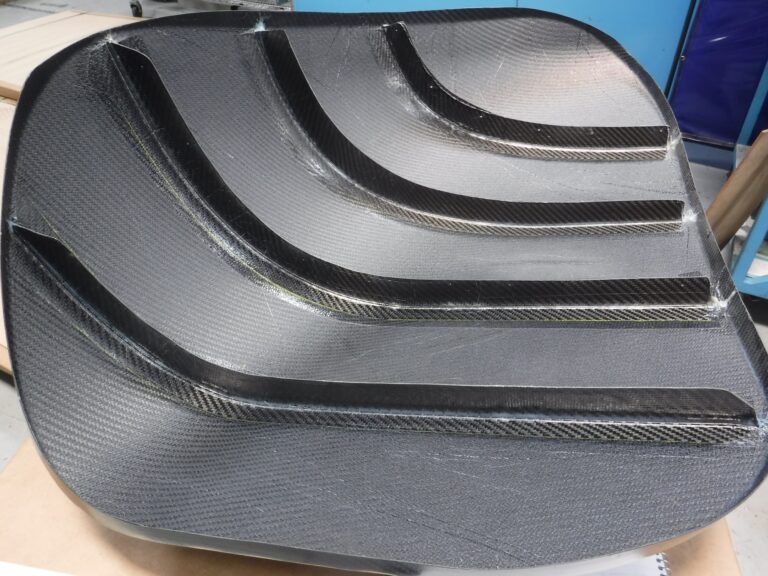 Ribbed composite aerospace structure for lightweight strength.